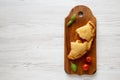 Homemade Deep Fried Italian Panzerotti Calzone with sauce on a rustic wooden board on a white wooden background, top view. Space Royalty Free Stock Photo