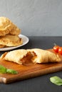 Homemade Deep Fried Italian Panzerotti Calzone with sauce, side view. Copy space Royalty Free Stock Photo