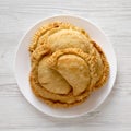 Homemade Deep Fried Italian Panzerotti Calzone with sauce on a white plate on a white wooden table, top view. Flat lay, overhead, Royalty Free Stock Photo