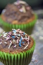 Homemade, delicious cocoa muffins with dark chocolate and multicolored sugar sprinkles
