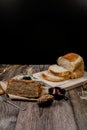 Homemade delicious freshly baked bread classic sweet banana bread sliced with blueberry/strawberry jam and butter knife on a woode Royalty Free Stock Photo