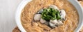 Delicious oyster vermicelli in a bowl on wooden table background