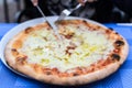 Homemade delicious margarita pizza on dish over table in restaurant