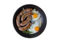 Homemade delicious sausages and fried eggs in a pan