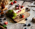 Homemade delicious slice of raspberry biscuit cake with white cream, strawberries, blueberries Royalty Free Stock Photo