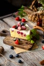 Homemade delicious slice of raspberry biscuit cake with white cream, strawberries, blueberries Royalty Free Stock Photo