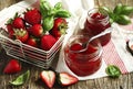 Homemade delicious strawberry jam with basil in a glass jar and Royalty Free Stock Photo