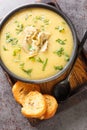 Homemade delicious vegetable cream artichoke soup served with toast close-up in a bowl on the table. Vertical top view Royalty Free Stock Photo