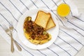 Homemade Denver Omelette on a white plate on cloth, overhead view. Flat lay, top view, from above