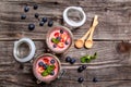Homemade dessert panna cotta with strawberry sauce, fresh berries, mint on a wooden background. Top view Royalty Free Stock Photo
