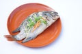 Homemade dilicious steamed fish on brown plate. Original thai food.Healthy and high protine food Royalty Free Stock Photo