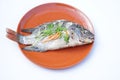 Homemade dilicious steamed fish on brown plate. Original thai food.Healthy and high protine food Royalty Free Stock Photo