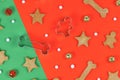 Homemade dog christmas cookies in shape of bones, stars and gingerbread men with cookie cutters and seasonal bell Royalty Free Stock Photo