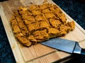 Home made dog treats made of pumpkin on a wooden cutting block with a knife Royalty Free Stock Photo