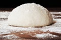 Homemade dough ball for pizza on floured wooden table