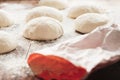 Homemade dough balls for pizza on floured wooden table Royalty Free Stock Photo