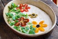 Homemade dough for delicious, italian focaccia in round baking tray. Decoration that looks like flowers in garden is made of red Royalty Free Stock Photo