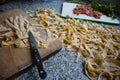 Homemade dough pasta made for a tasty dish. Ingredients for a delicious dinner