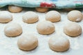 Homemade dough pies on the baking sheet ready for the oven for baking. Selective focus macro shot with shallow DOF Royalty Free Stock Photo