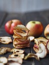Homemade dried fruit Apple chips on a rustic wooden dark table. Natural healthy food.The benefits of dried fruit Royalty Free Stock Photo