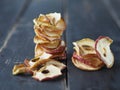 Homemade dried fruit Apple chips on a rustic wooden dark table. Natural healthy food.The benefits of dried fruit Royalty Free Stock Photo