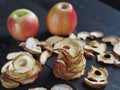 Sun dried apple chips on a rustic wooden table.Healthy snack.Selective focus Royalty Free Stock Photo