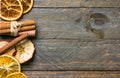 Homemade dried fruits slices of orange apple cinnamon sticks on on old plank wood background. New year Christmas decoration