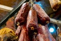 Homemade dry salami - traditional meat products, by smoked pork hanging in smokehouse Royalty Free Stock Photo