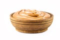 Homemade dulce de leche, sour cream or pasty caramel, in rustic wooden bowl, isolated white background