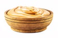 Homemade dulce de leche, sour cream or pasty caramel, in rustic wooden bowl, isolated white background