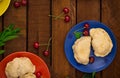 Homemade dumplings with cherries. Wooden background. Top view. Close-up