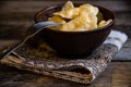 Homemade dumplings in clay pots on the kitchen table, fork and folklor napkin.