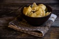 Homemade dumplings in clay pots on the kitchen table, fork and folklor napkin. Royalty Free Stock Photo