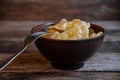 Homemade dumplings in clay pots on the kitchen table, fork and folklor napkin. Royalty Free Stock Photo