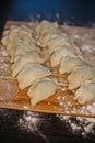 Homemade dumplings on floured wooden board Royalty Free Stock Photo