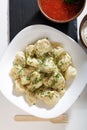 Homemade dumplings in the kitchen without decorations. ready-made dumplings on a white plate, served with sour cream and adjika Royalty Free Stock Photo