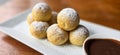 Homemade Dutch poffertjes mini pancakes with icing powdered sugar and chocolate fillings with additional chocolate sauce Royalty Free Stock Photo