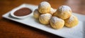 Homemade Dutch poffertjes mini pancakes with icing powdered sugar and chocolate fillings with additional chocolate sauce Royalty Free Stock Photo