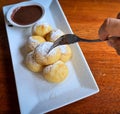 Homemade Dutch poffertjes mini pancakes with icing powdered sugar and chocolate fillings with additional chocolate sauce Royalty Free Stock Photo