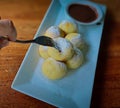 Homemade Dutch poffertjes mini pancakes with icing powdered sugar and chocolate fillings with additional chocolate sauce Royalty Free Stock Photo