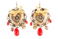 Homemade earrings with red stones and golden bows