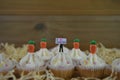 Eastertime cupcakes with carrot decorations and a miniature person figurine holding a sign for love Easter