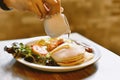 Homemade easy breakfast meal, Pancakes stack with hand pouring syrup.