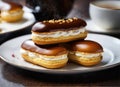 Homemade eclairs on a plate with a cup of tea