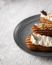 Homemade eclairs, three brewing cakes with glaze on the plate close up Royalty Free Stock Photo