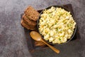 Homemade egg salad with apples and pickles seasoned with sauce served with rye bread close-up in a bowl on the table. Horizontal