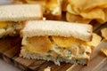 Homemade Egg Salad Sandwich with Potato Chips on a wooden board, side view. Close-up Royalty Free Stock Photo