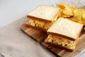 Homemade Egg Salad Sandwich with Potato Chips on a wooden board, side view. Copy space Royalty Free Stock Photo