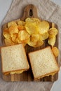 Homemade Egg Salad Sandwich with Potato Chips on a wooden board, top view Royalty Free Stock Photo