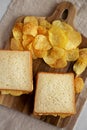 Homemade Egg Salad Sandwich with Potato Chips on a wooden board, top view. Close-up Royalty Free Stock Photo